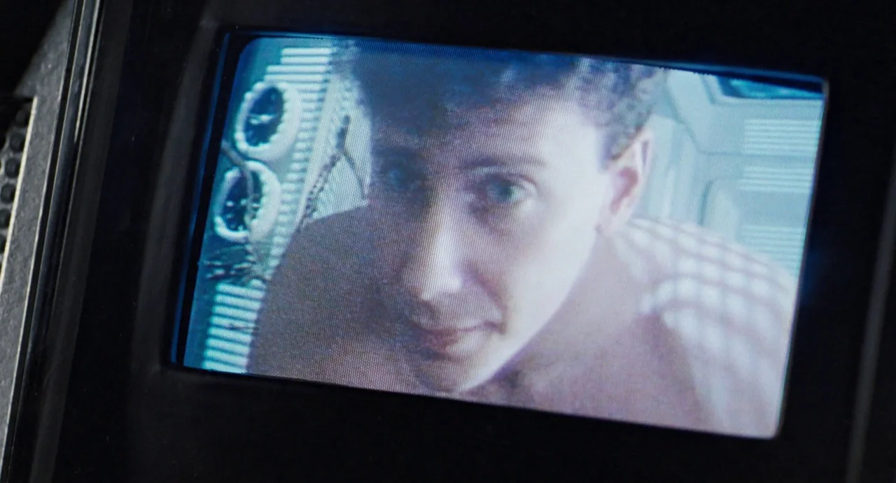 Aliens (1986) movie still: closeup — A close-up view through a small cathode ray tube video monitor display. A young man stares directly into the…