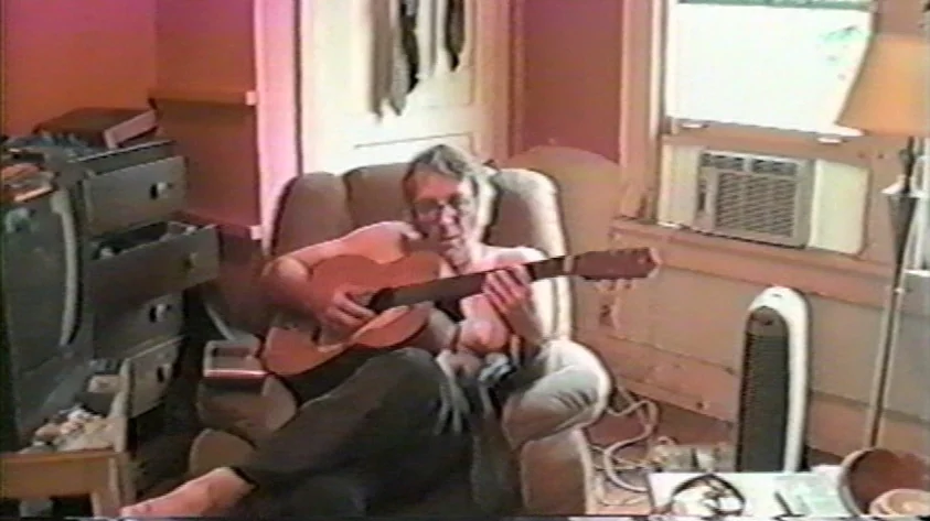 Trash Humpers (2009) movie still: medium — A cluttered room features a television, a window unit air conditioner, and miscellaneous belongings. A…