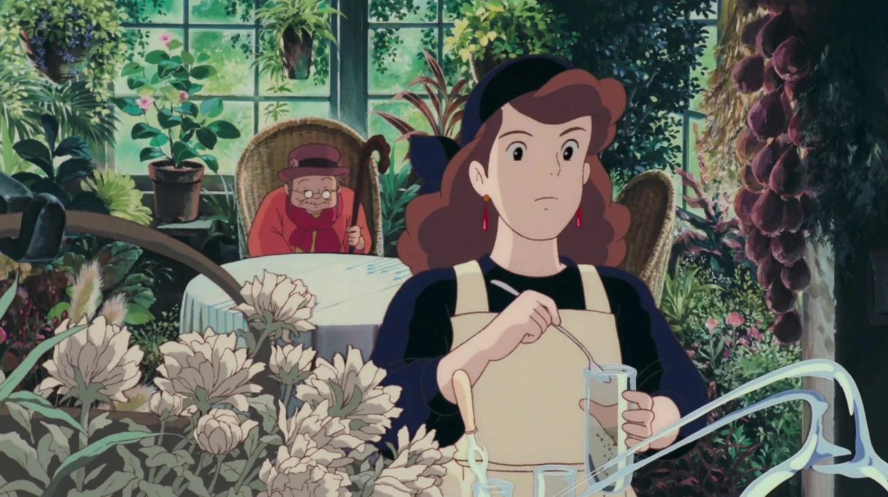Kiki’s Delivery Service (1989) movie still: medium — A sunlit greenhouse filled with hanging baskets and various potted plants surrounding two…