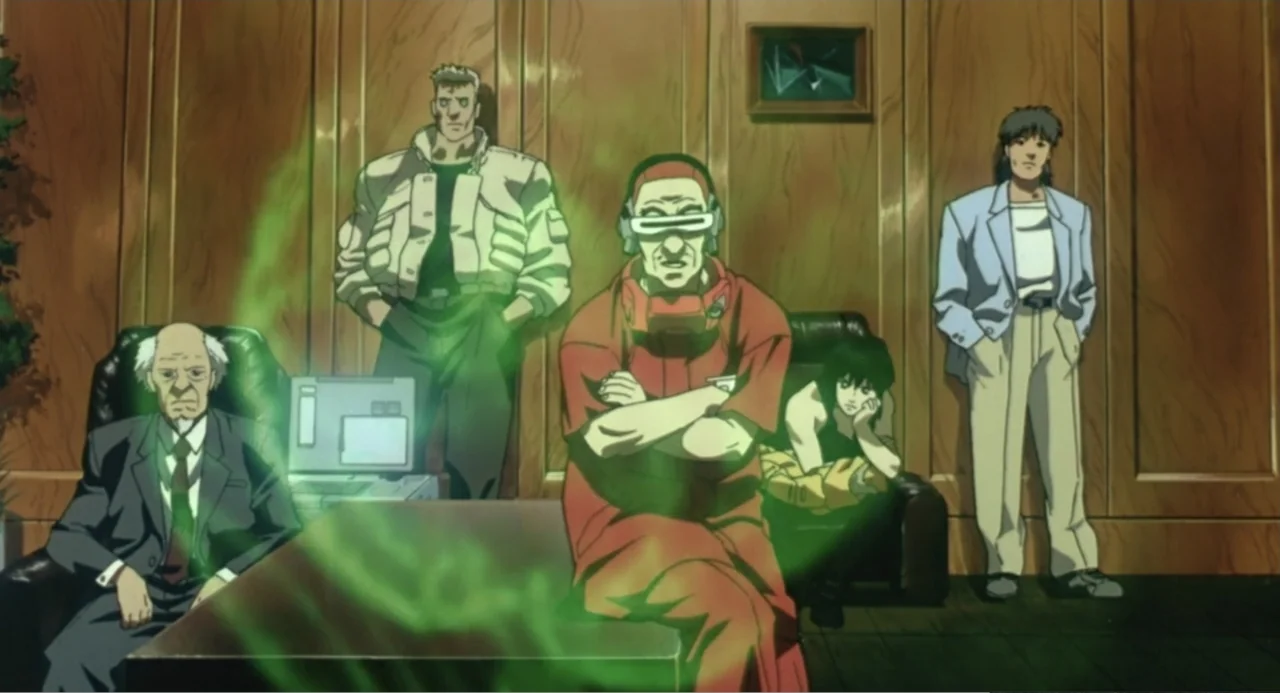Ghost in the Shell (1995) movie still: medium — A wood-paneled office space contains five individuals positioned around a desk. One man sits in the…
