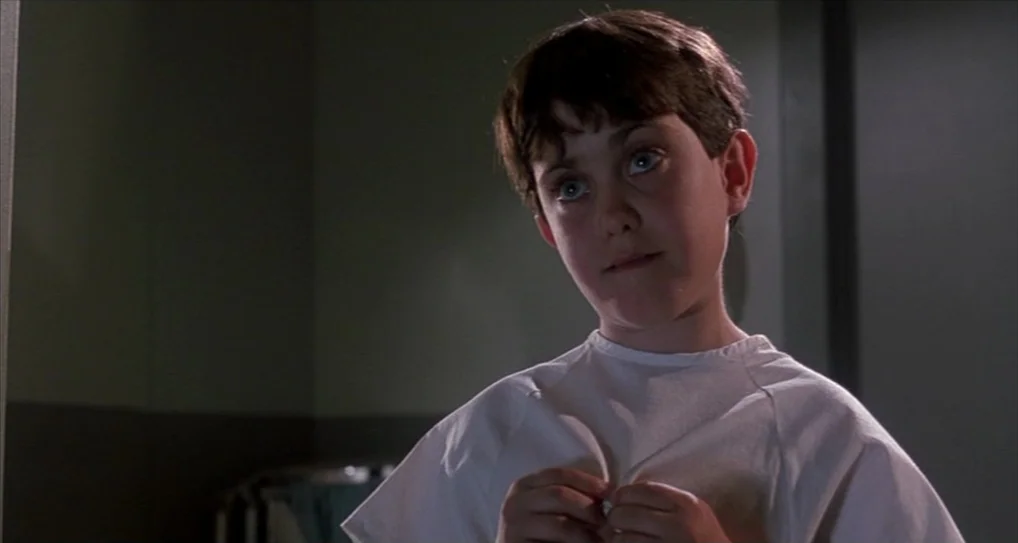 A Nightmare On Elm Street 5: The Dream Child (1989) movie still: medium — A dimly lit room with muted green walls suggests a clinical hospital…
