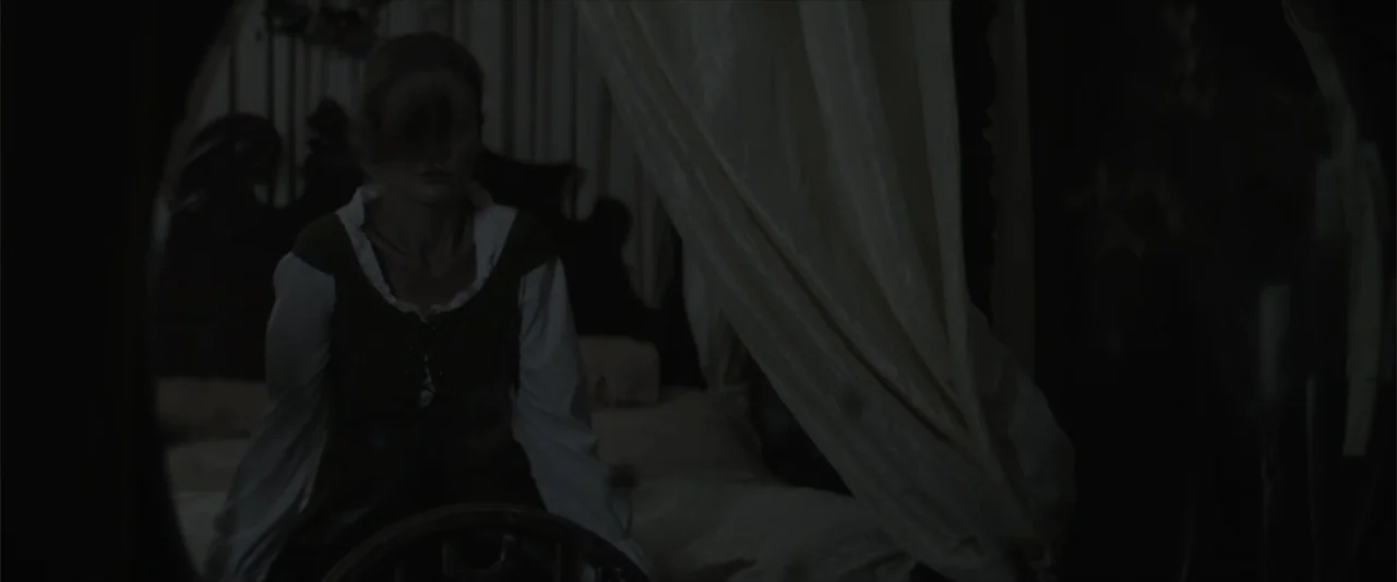 Cinderella's Curse (2024) movie still: medium — A dimly lit room contains a period-style four-poster bed draped with white fabric. A woman sits in…