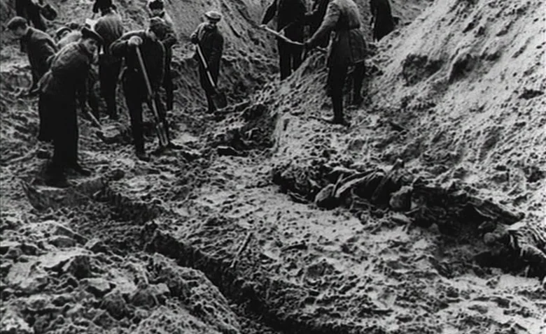 Sweet Movie (1974) movie still: wide — A group of men labor in a deep, narrow trench dug into sandy soil. They are using shovels to move earth while…