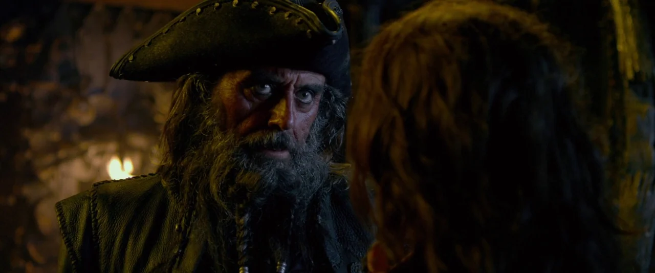 Pirates of the Caribbean: On Stranger Tides movie still: medium — A dimly lit, wooden-paneled space reminiscent of a historical ship interior at…