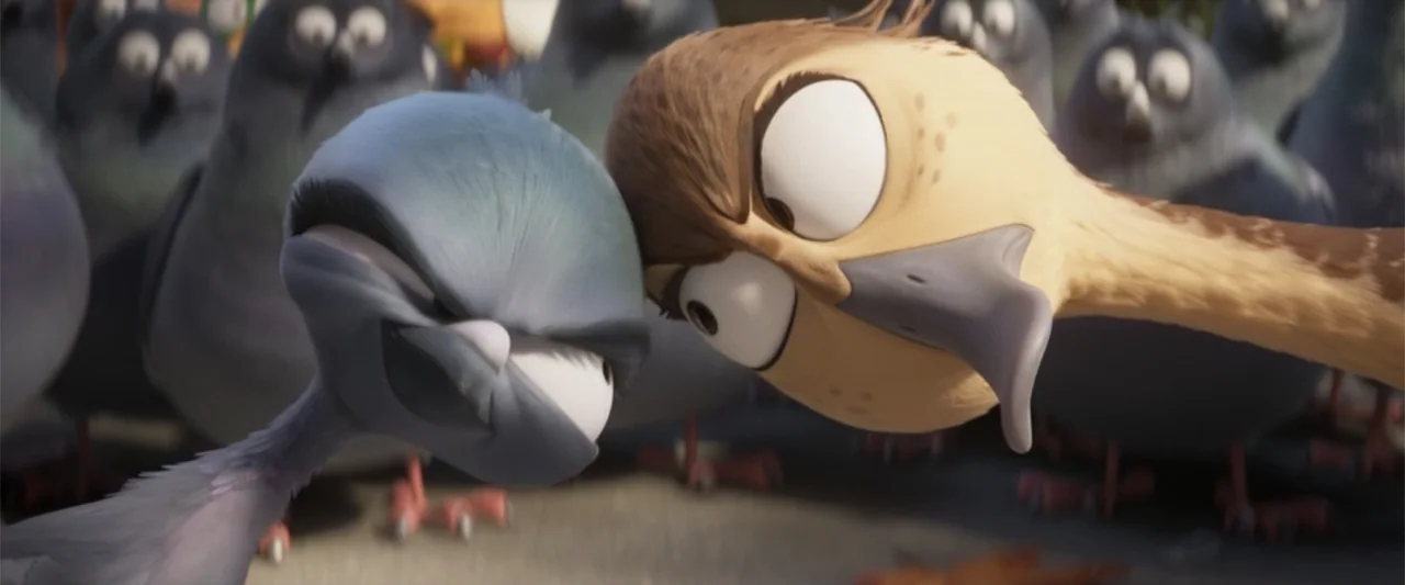 Migration (2023) movie still: closeup — A group of animated pigeons congregates on a paved outdoor surface in daylight. Two prominent pigeons stand…