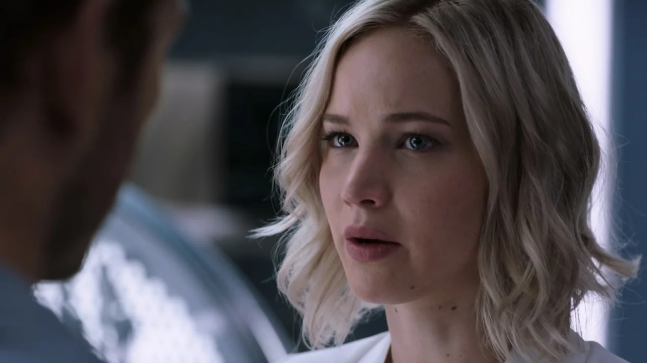 Passengers (2016) movie still: closeup — A modern, sleek interior featuring metallic surfaces and clean architectural lines. A woman with short…