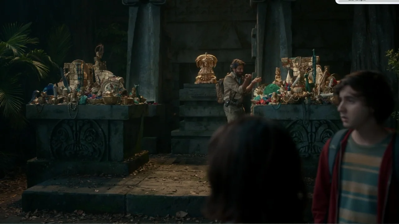 Dora and the Lost City of Gold (2019) movie still: medium — A dark stone temple chamber features two stone altars piled with various ancient…