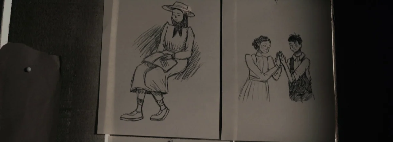 Women Talking (2022) movie still: closeup — Two pencil sketches are pinned against a dark, textured wall surface. The illustrations depict figures…