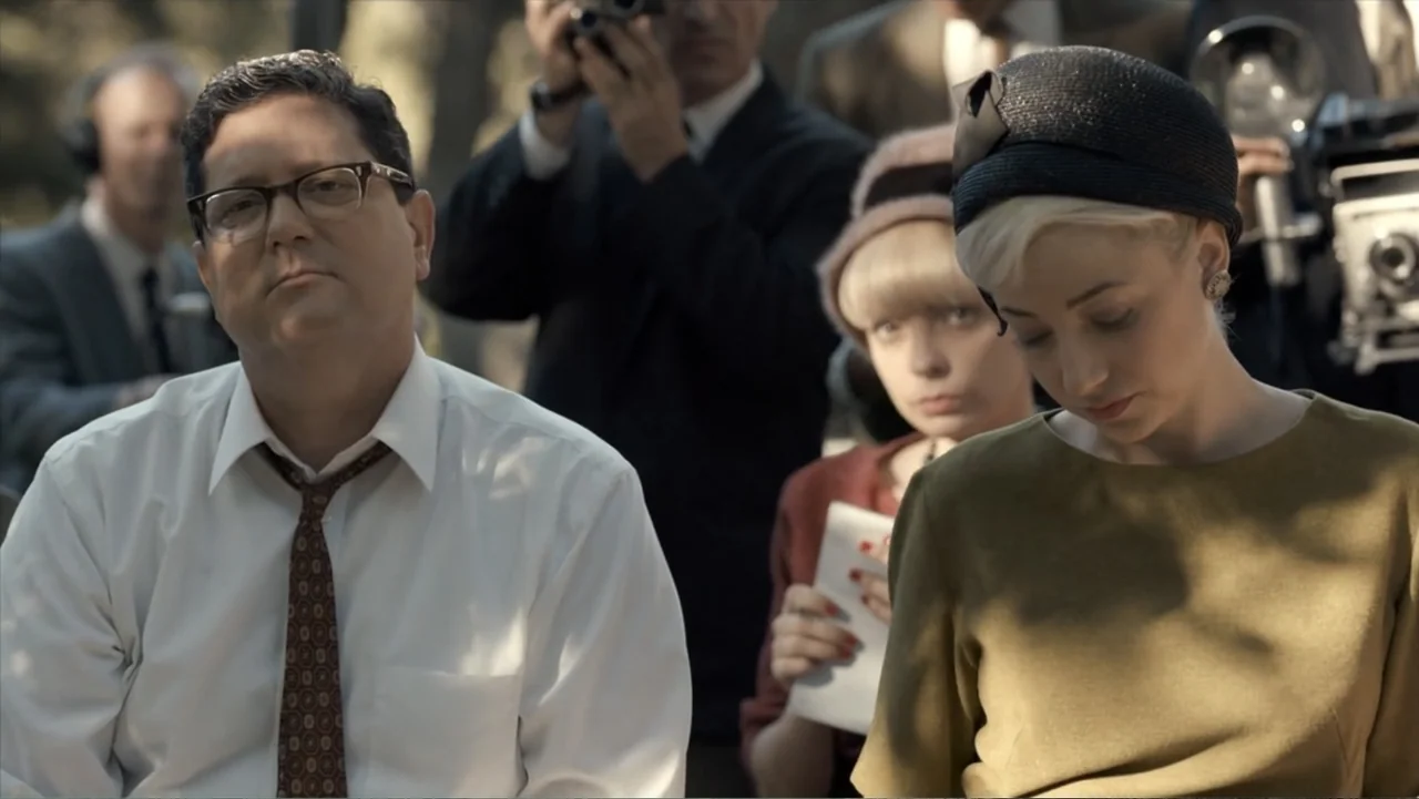 All the Way (2016) movie still: medium — An outdoor press event features a seated man and woman in 1960s attire. Photographers surround the couple…