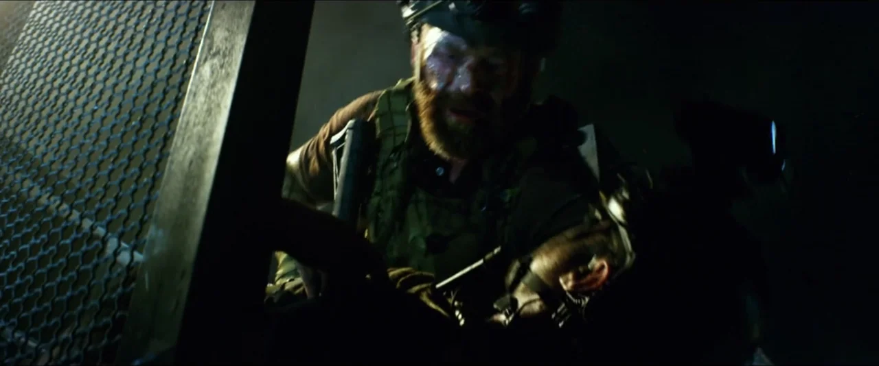 13 Hours: The Secret Soldiers of Benghazi (2016) movie still: medium — A dimly lit stairwell features a heavy metal mesh grating in the foreground.…