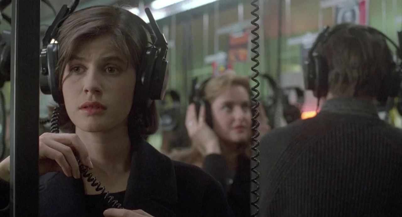 Three Colours: Red (1994) movie still: medium — A language lab features partitioned desks with students wearing large black wired headphones. A…