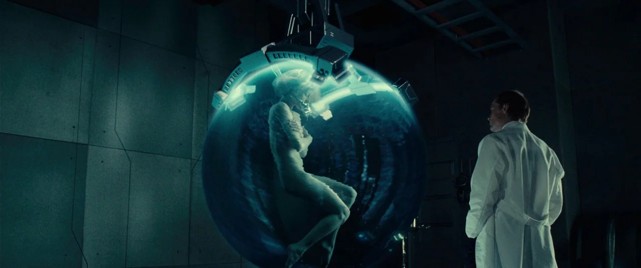 Resident Evil: Extinction (2007) movie still: medium — A stark, industrial laboratory features a large, suspended spherical containment pod emitting…