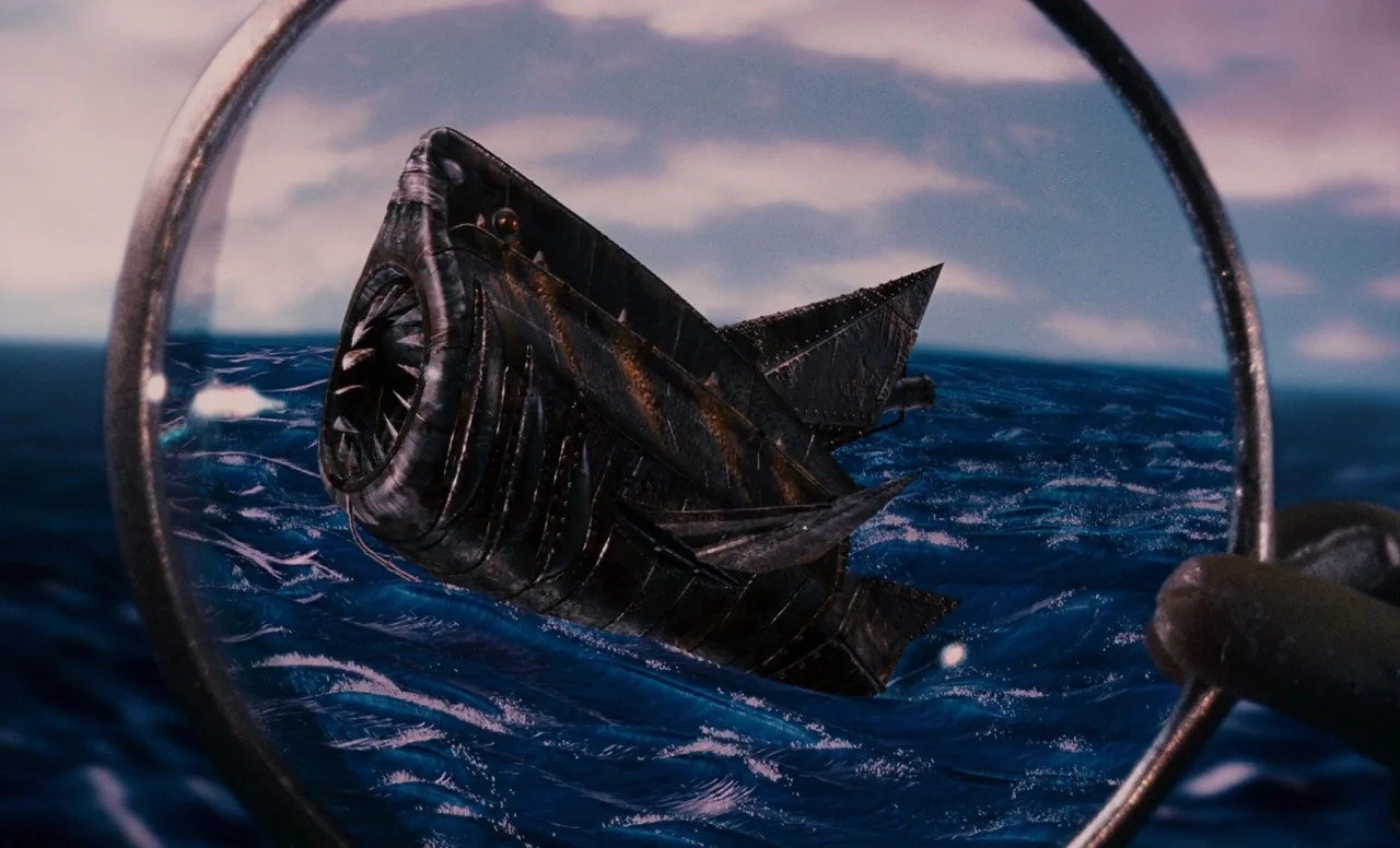 James and the Giant Peach (1996) movie still: closeup — A metal submersible constructed in the shape of a fish floats on ocean waves. The object is…