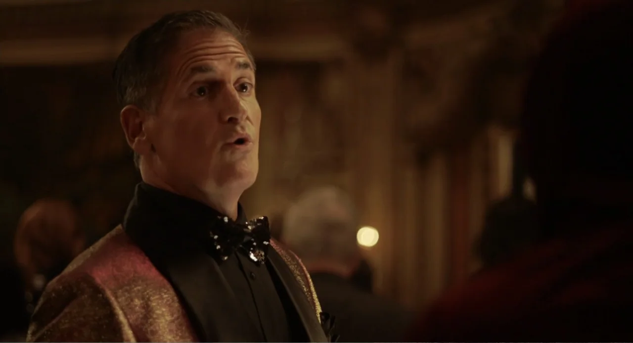 House Party (1990) movie still: medium — A dimly lit ballroom with blurred architectural elements and warm ambient lighting. A middle-aged man in a…