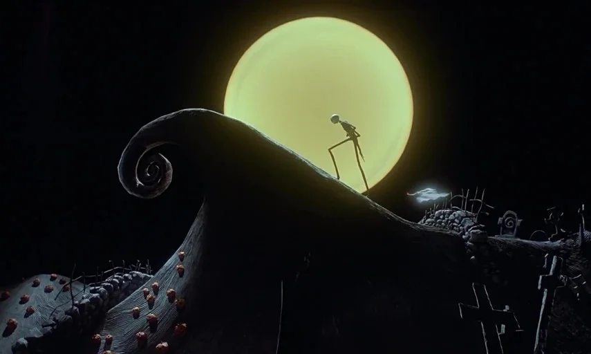 The Nightmare Before Christmas (1993) movie still: wide — A dark rocky hilltop with gravestones at night under a giant bright moon. A thin skeletal…