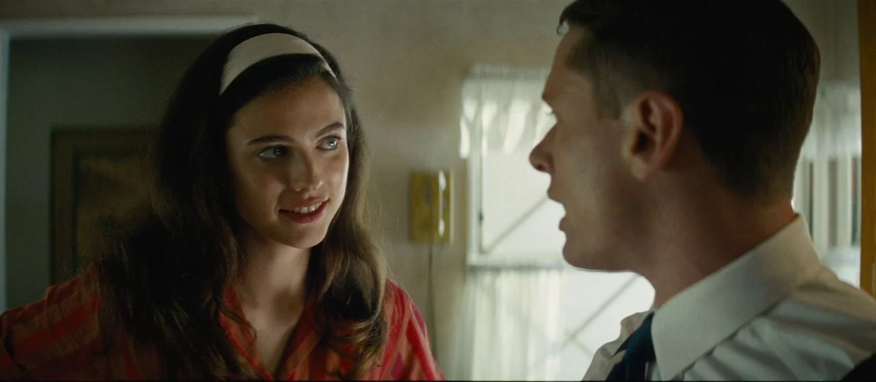 Seberg (2019) movie still: medium — A woman and a man stand in a room with white curtains. They are facing each other in conversation.