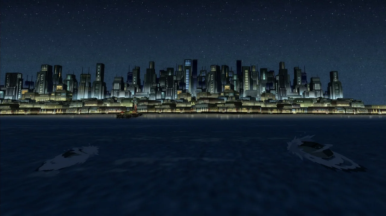 Justice Society: World War II (2021) movie still: establishing — A dense urban skyline filled with illuminated skyscrapers sits along a dark calm…