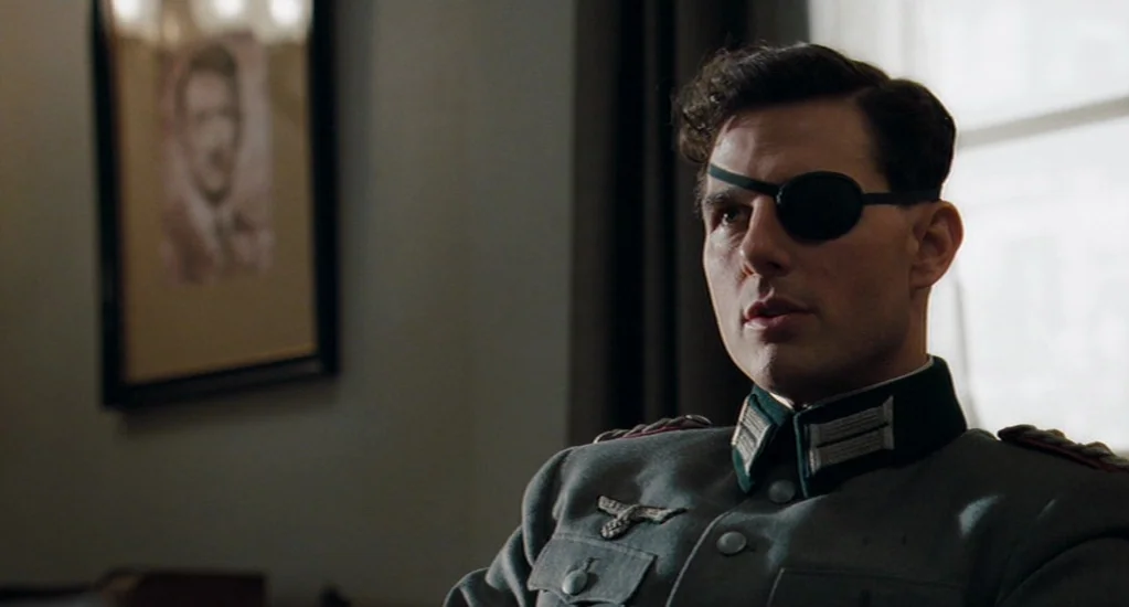 Valkyrie (2008) movie still: medium — An interior office space with muted walls and a framed portrait in the background. A man in a historical…