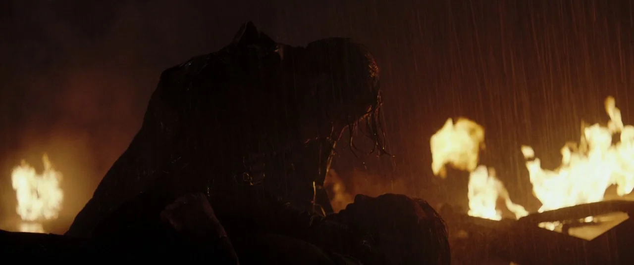 Rogue One: A Star Wars Story (2016) movie still: medium — An outdoor area filled with fire and torrential rain obscures the surrounding environment.…