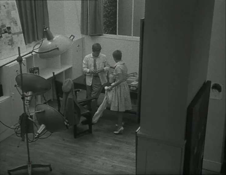 À Bout De Souffle (Breathless) (1960) movie still: wide — A spartan apartment interior features a large industrial floor lamp and a simple desk. A…