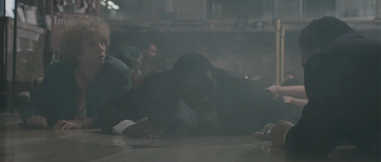 Inside Man (2006) movie still: medium — A smoky interior bank lobby features marble flooring and scattered papers on the ground. Three people in…