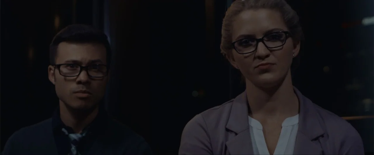 Anomaly (2006) movie still: medium — A dimly lit corporate environment at night provides a dark and minimalist background. Two professional…