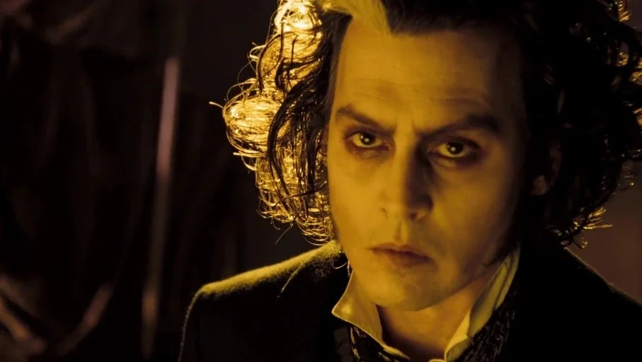 Sweeney Todd: The Demon Barber of Fleet Street (2007) movie still: closeup — A dimly lit room with heavy shadows and a golden light source nearby. A…