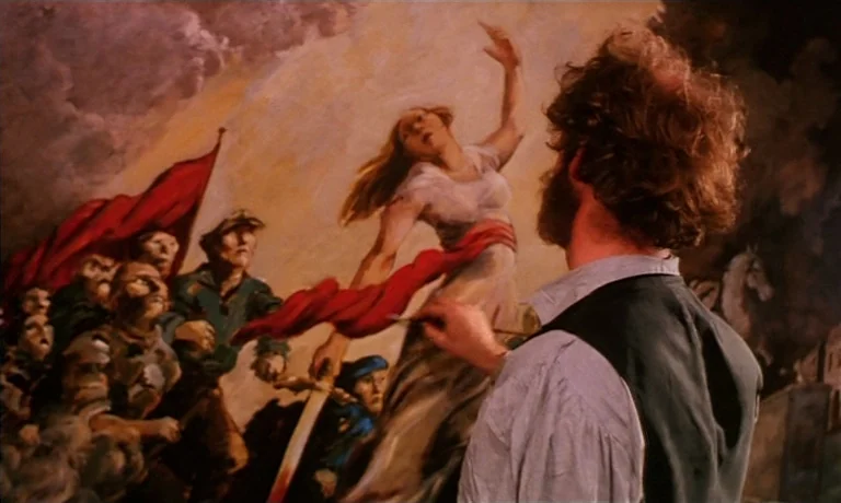 Katie Tippel (1975) movie still: medium — An artist stands before a massive, dramatic mural depicting a revolutionary scene. The painting features a…