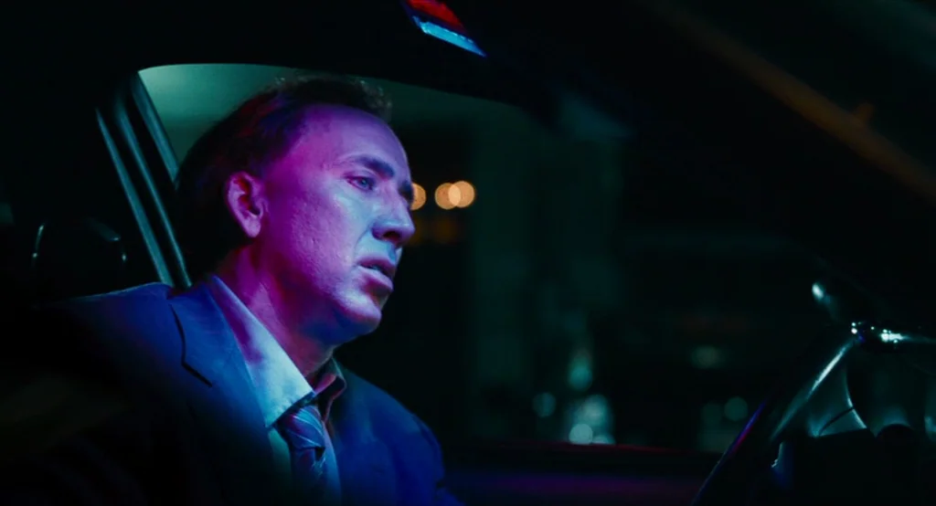 Bad Lieutenant: Port Of Call New Orleans (2009) movie still: medium — The interior of a modern car at night illuminated by external city neon…