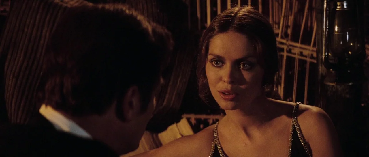 The Spy Who Loved Me (1977) movie still: medium — A dimly lit restaurant interior features dark wood textures and hanging decorative metal accents.…