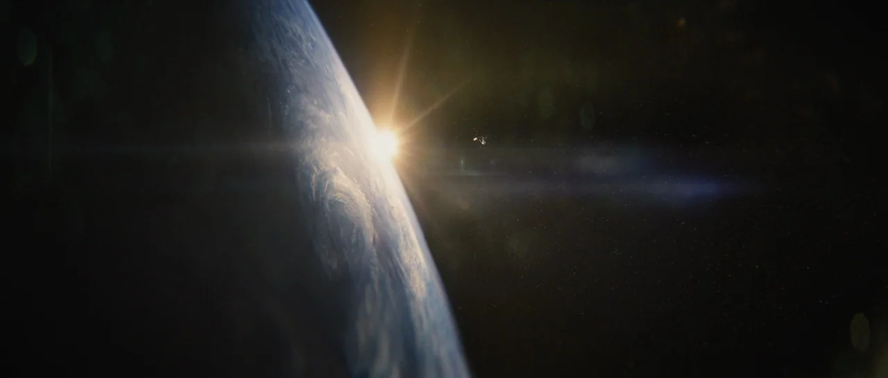 Star Trek Beyond (2016) movie still: establishing — The curve of the Earth is visible against the deep darkness of space. A bright sun flares behind…