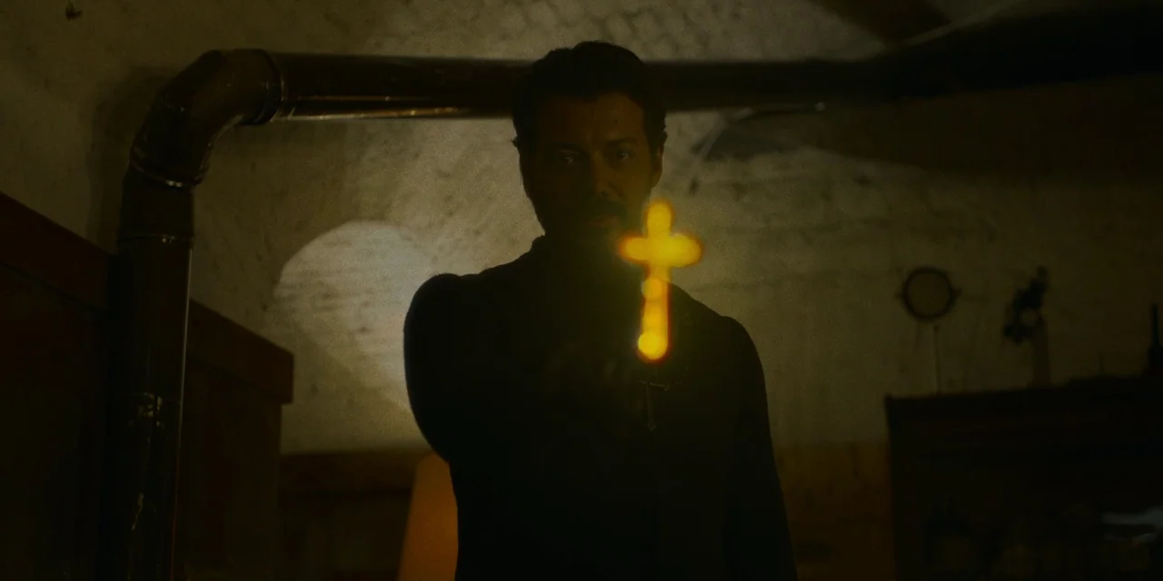 Immaculate (2024) movie still: medium — A dark subterranean space features arched masonry ceilings and exposed metal ventilation ductwork. A man…