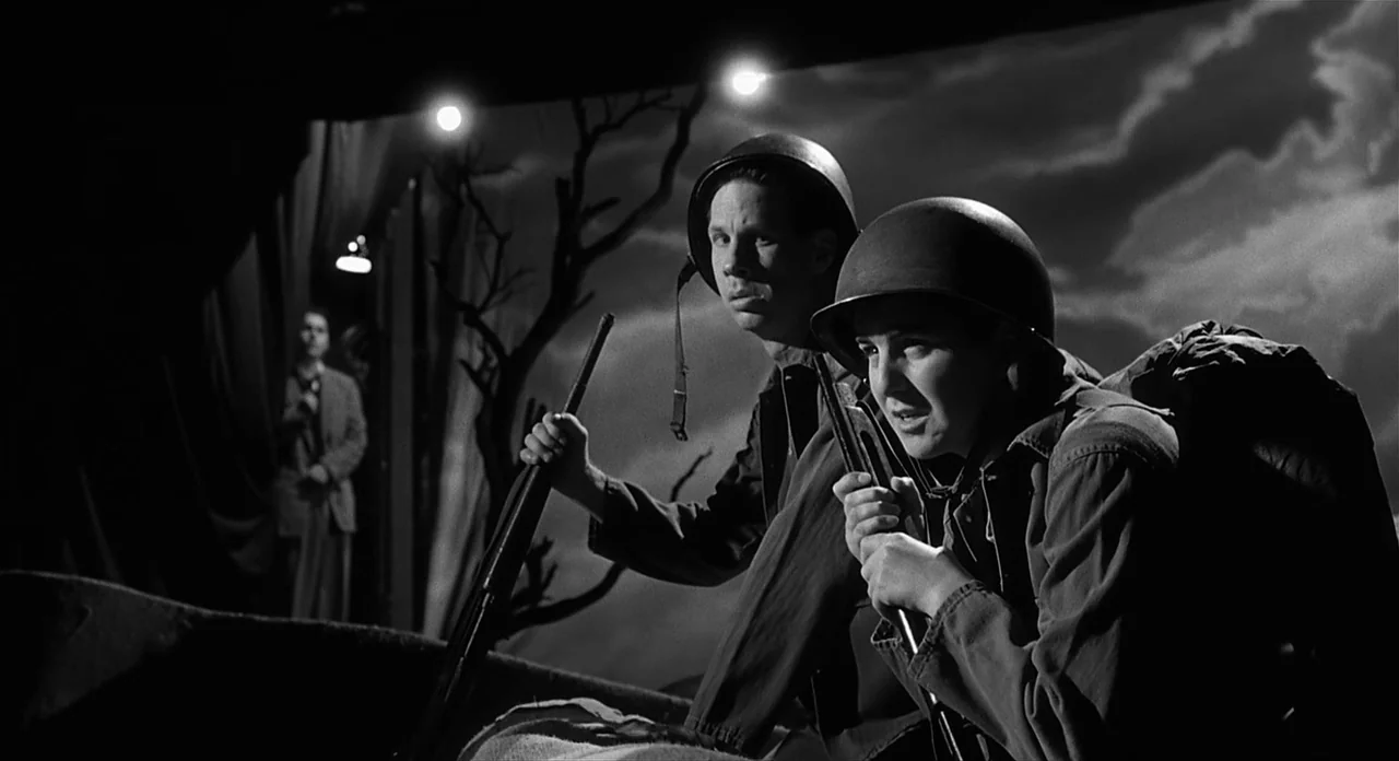Ed Wood (1994) movie still: medium — A theatrical production features two soldiers on a set designed to resemble a battlefield. A painted backdrop…