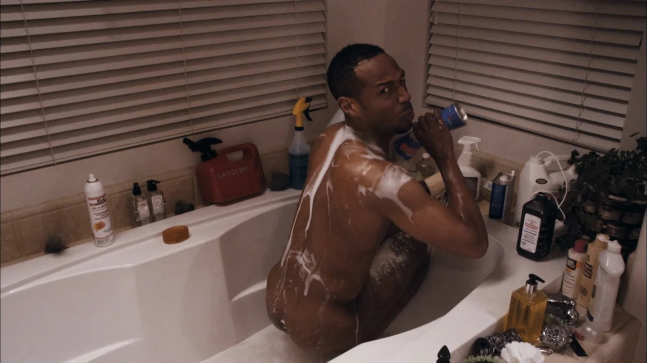 A Haunted House (2013) movie still: medium — A residential bathroom features a large white soaking tub surrounded by numerous cleaning products. A…