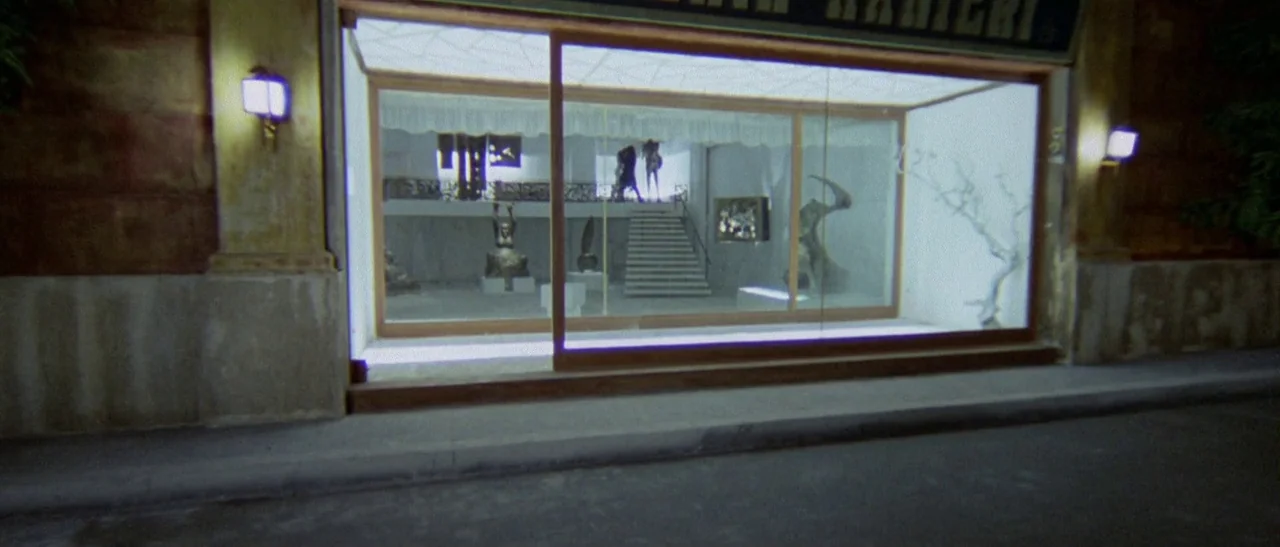 The Bird With The Crystal Plumage (1970) movie still: wide — An art gallery storefront at night features a large glass display window facing the…