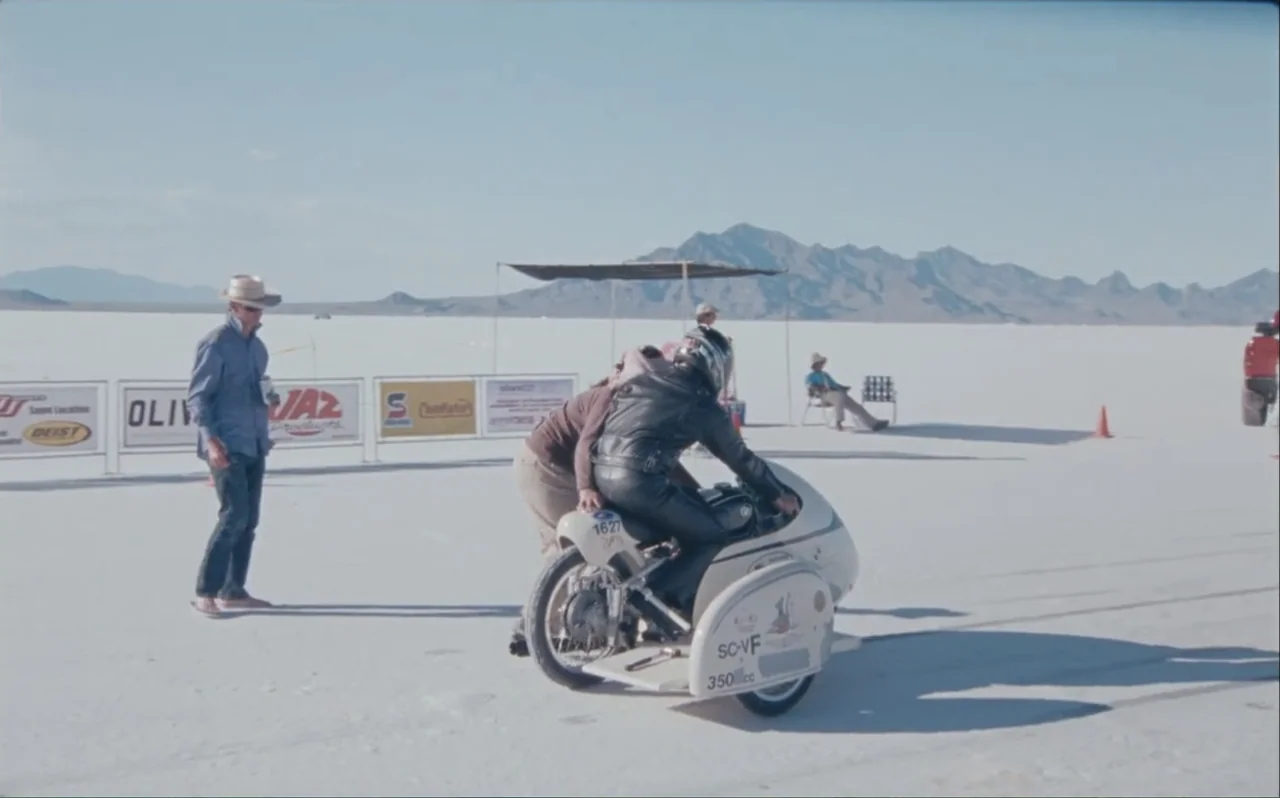 The Greasy Hands Preachers (2014) movie still: fullbody — An expansive white salt flat with distant mountains under a clear bright sky. A person in…