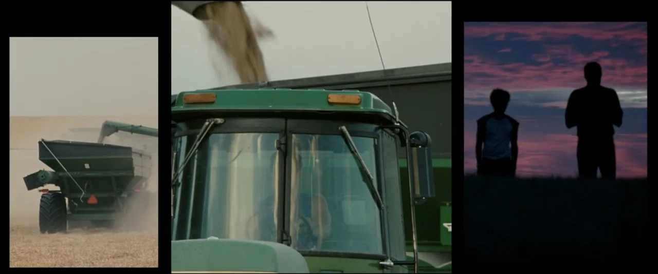 Into the Wild (2007) movie still: wide — A vast expanse of rural farmland features a large green tractor harvesting grain crops. Silhouettes of two…