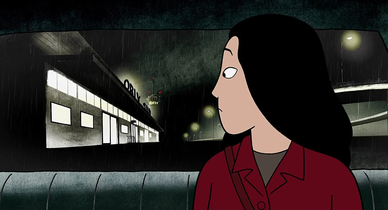 Persepolis (2007) movie still: medium — A woman sits inside a car during a dark, rainy night. Outside the window, the illuminated Orly Sud airport…