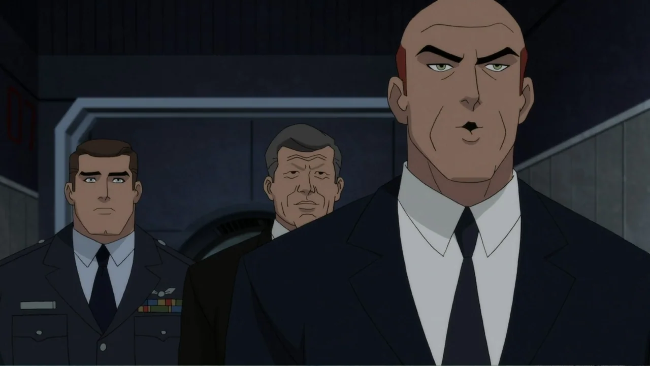 Superman: Red Son (2020) movie still: medium — A dimly lit indoor corridor with metallic paneled walls and a wide arched doorway. Three men wearing…