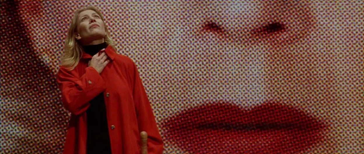 All About My Mother (1999) movie still: medium — An interior space features a wall covered in a large-scale Pop Art print. A woman stands in front…