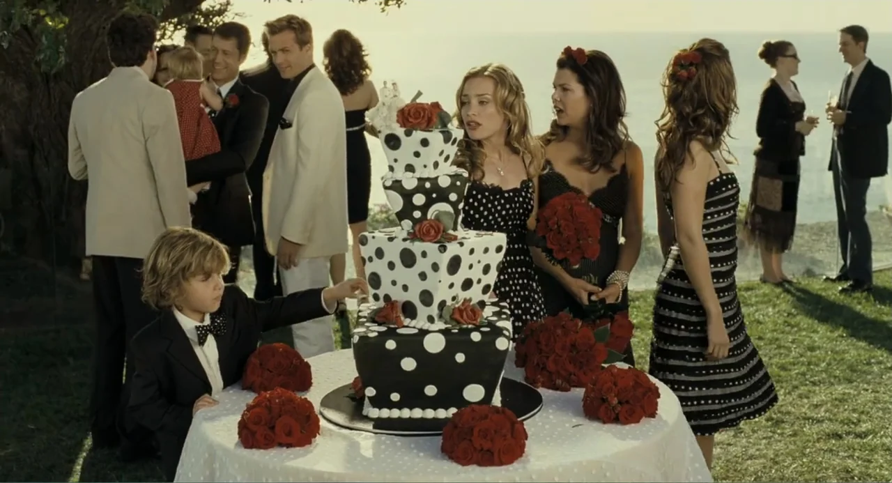 Because I Said So (2007) movie still: medium — An outdoor wedding reception overlooks the ocean during the golden hour of the day. A young boy in a…