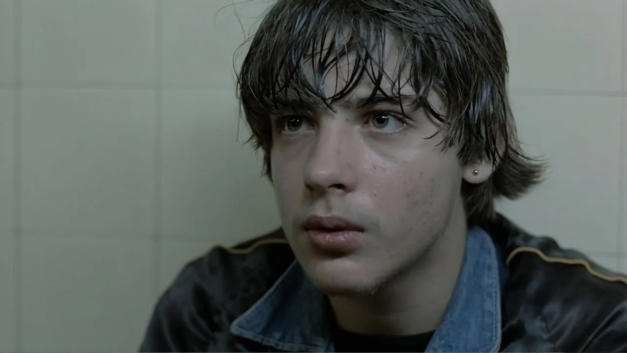 Christiane F. (1981) movie still: closeup — A close-up shot captures a young man with wet hair in a tiled bathroom. He gazes off-camera against the…