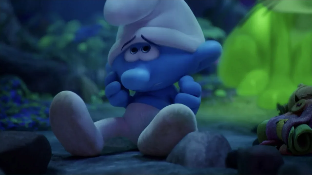 Smurfs: The Lost Village (2017) movie still: medium — A forest floor at night contains dark rocks and indistinct glowing foliage in the background.…
