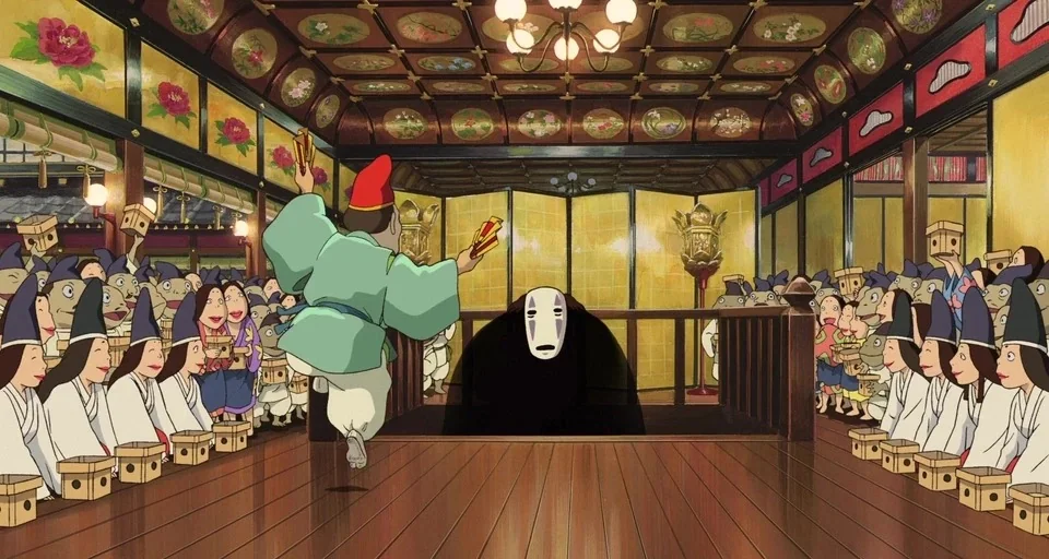 Spirited Away (2001) movie still: wide — A spacious hall with ornate floral ceiling panels and traditional Japanese golden sliding screens. A crowd…