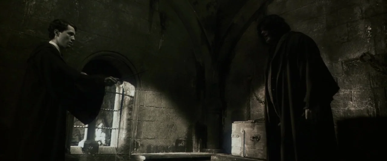 Harry Potter and the Chamber of Secrets (2002) movie still: medium — A dark stone room with vaulted ceilings and a small barred window with light. A…