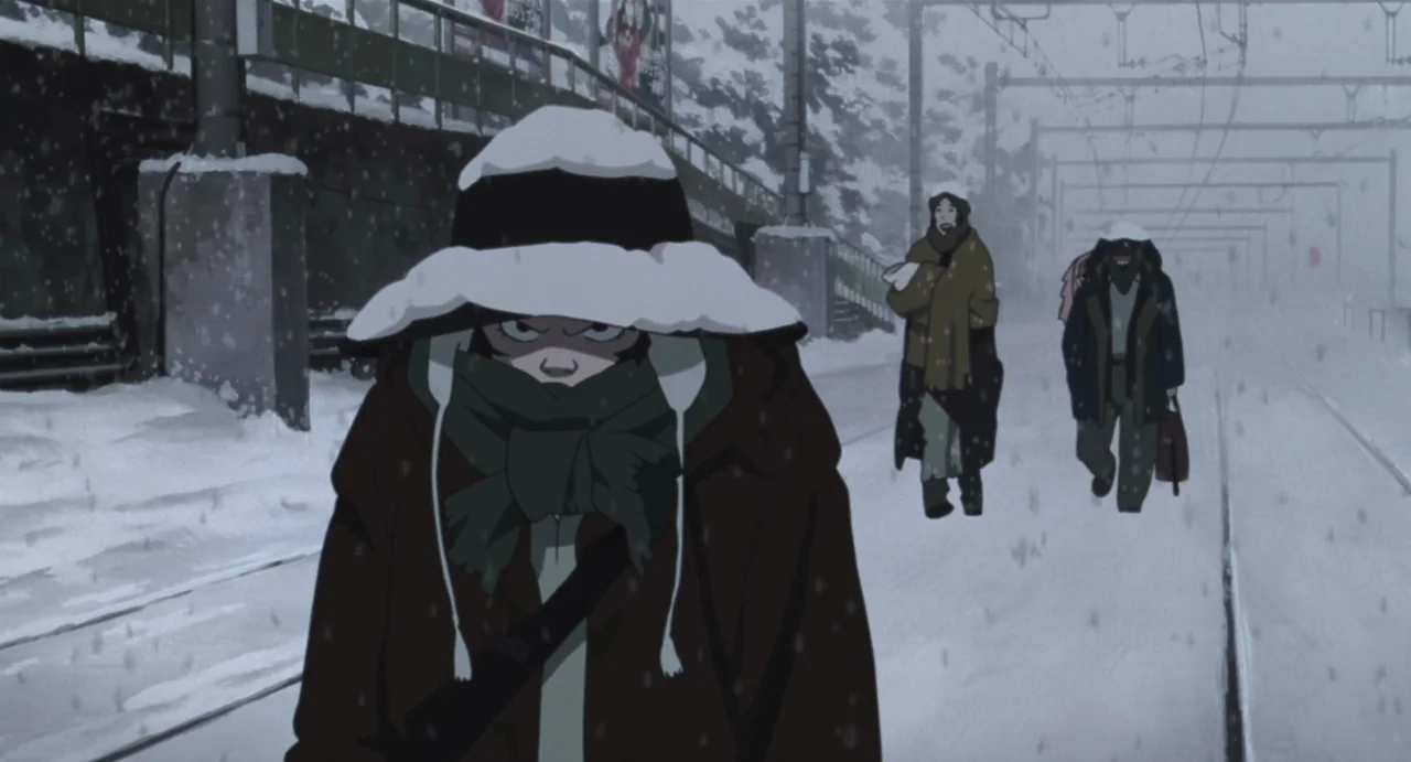 Tokyo Godfathers (2003) movie still: medium — A snow-covered outdoor train platform during a winter storm with falling snowflakes. A young girl…