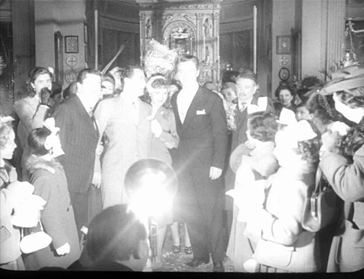 I Vitelloni (1953) movie still: fullbody — A crowded interior of an ornate religious building with statues and candles in back. A bride and groom…