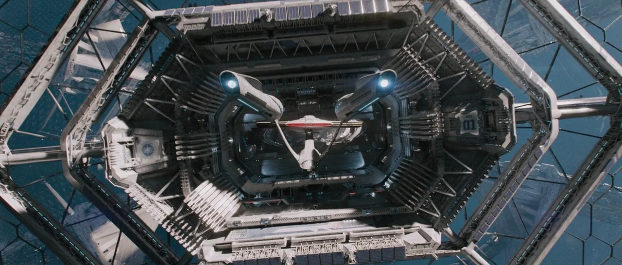 Star Trek Beyond (2016) movie still: establishing — A complex, large-scale hexagonal space station structure encompasses a starship in open space.…