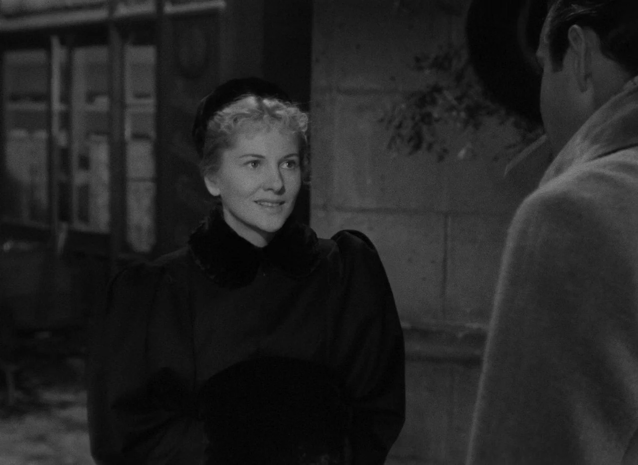 Letter From An Unknown Woman (1948) movie still: medium — An outdoor city sidewalk at night with stone walls and dark architectural features…