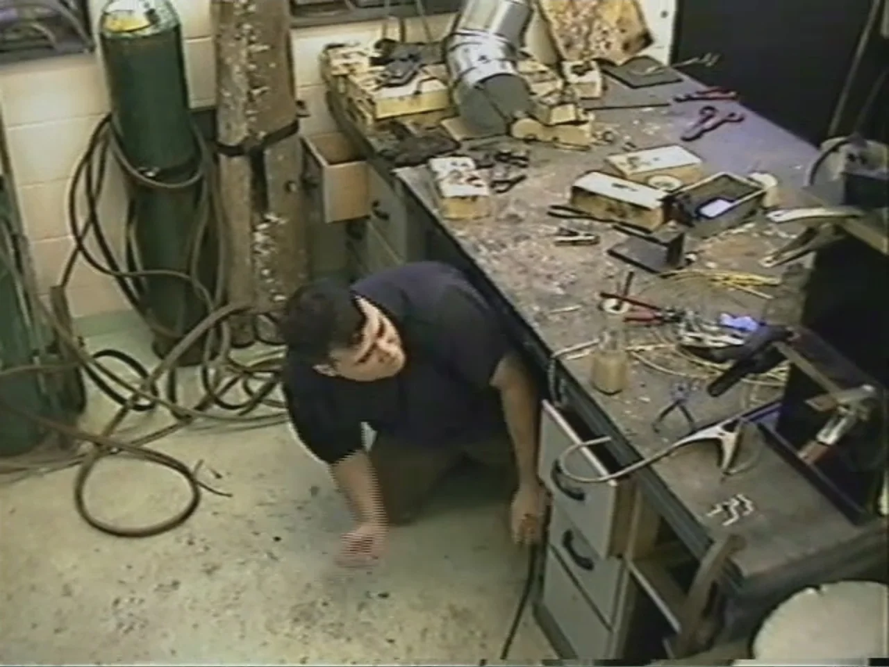 Dracula, Prisoner of Frankenstein (1972) movie still: medium — A cluttered workshop contains a metal workbench covered with various metal tools and…